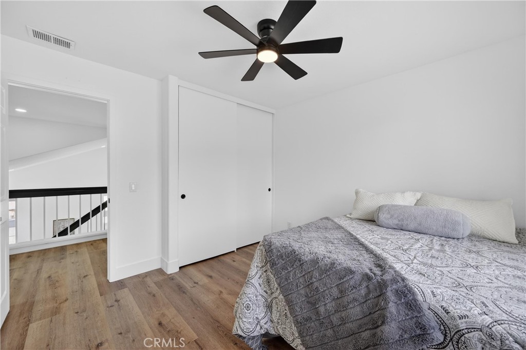 21484 Dickinson Road Moreno Valley, CA 92557 - Photo 39 of 48 a bedroom with a bed and a ceiling fan