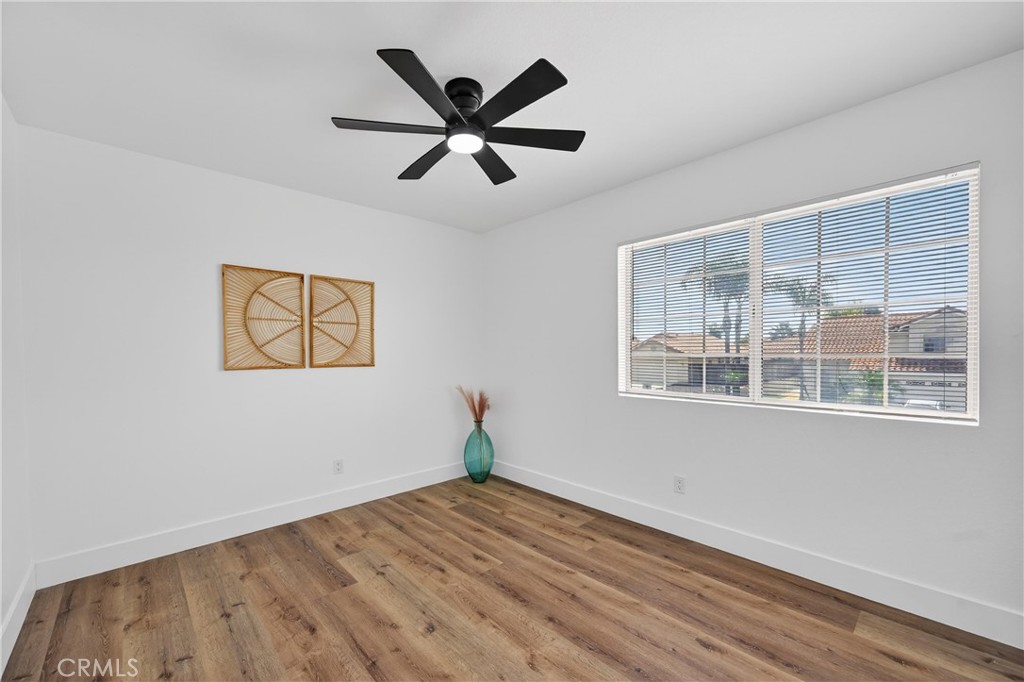 21484 Dickinson Road Moreno Valley, CA 92557 - Photo 40 of 48 a view of empty room with wooden floor and fan