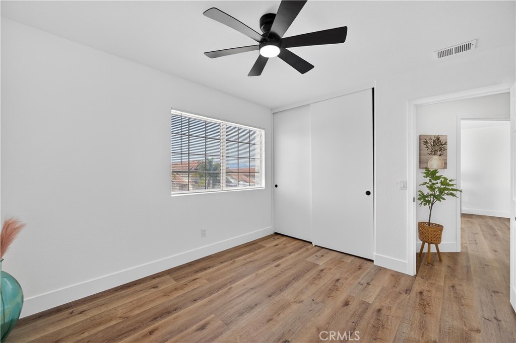 21484 Dickinson Road Moreno Valley, CA 92557 - Photo 41 of 48 a view of an empty room with wooden floor and a window