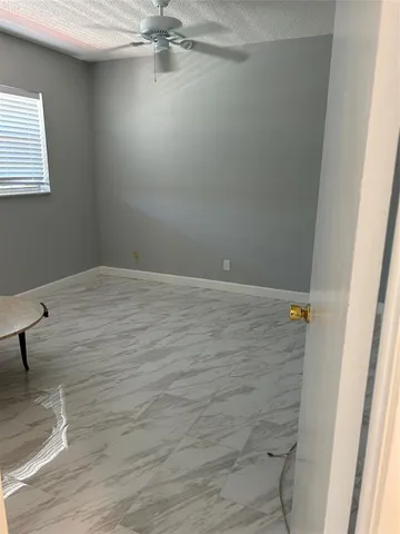 a white toilet sitting next to a bath tub