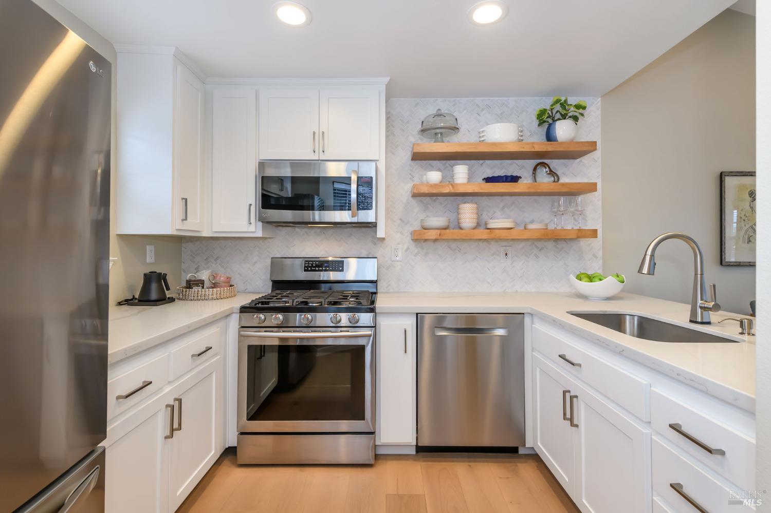 49 Mariners Circle San Rafael, CA 94903 - Photo 1 of 1 a kitchen with white cabinets stainless steel appliances and sink