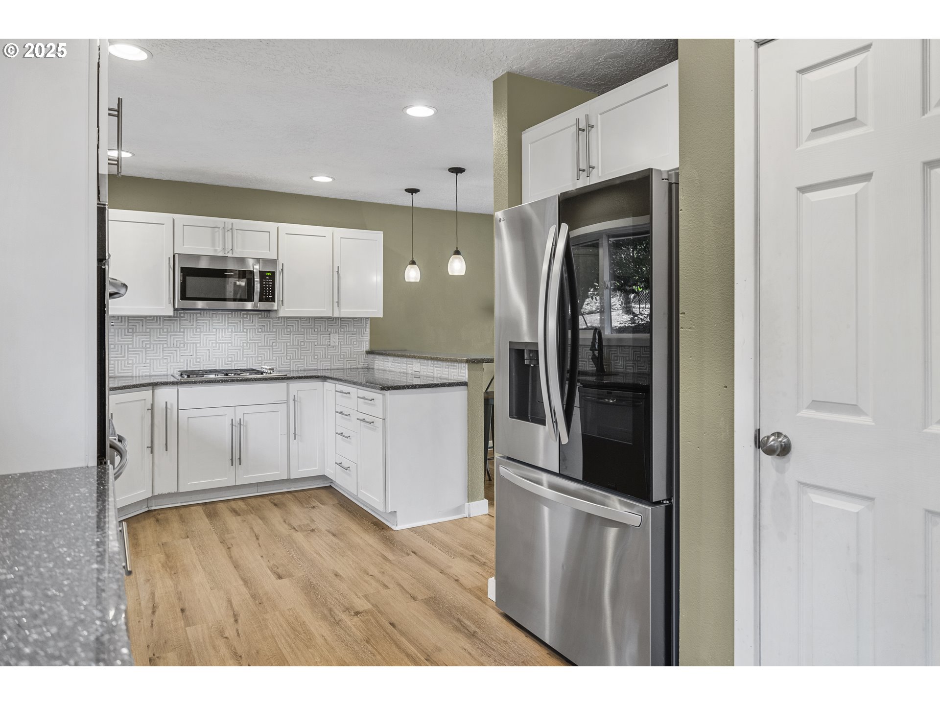 712 Southwest 4th Street Gresham, OR 97080 - Photo 12 of 47 a kitchen with stainless steel appliances granite countertop a refrigerator and a stove top oven