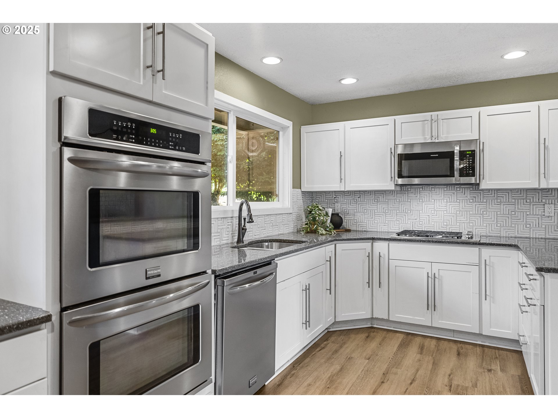 712 Southwest 4th Street Gresham, OR 97080 - Photo 13 of 47 a kitchen with cabinets stainless steel appliances and sink