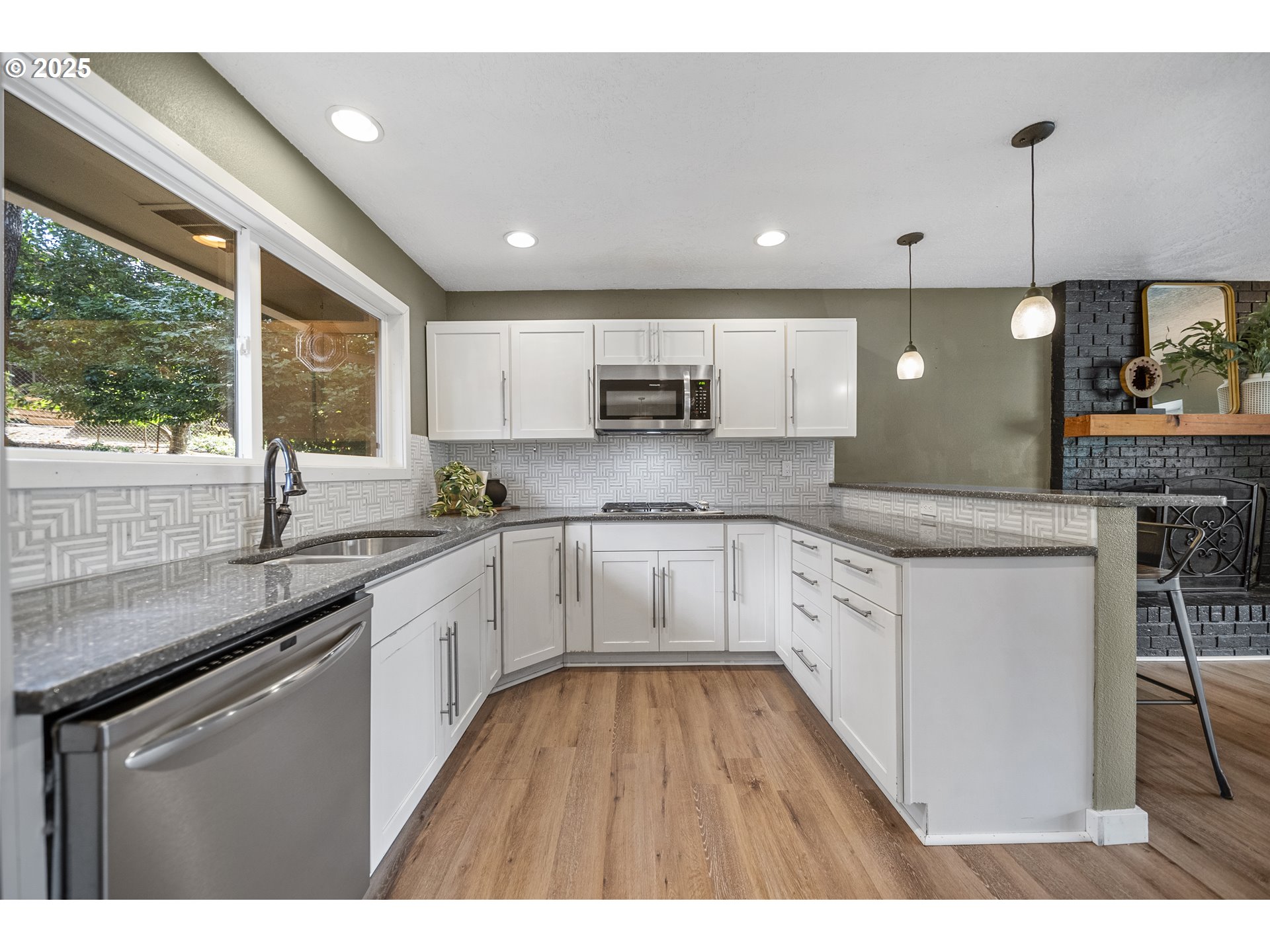 712 Southwest 4th Street Gresham, OR 97080 - Photo 15 of 47 a kitchen with granite countertop a stove a sink a center island and cabinets