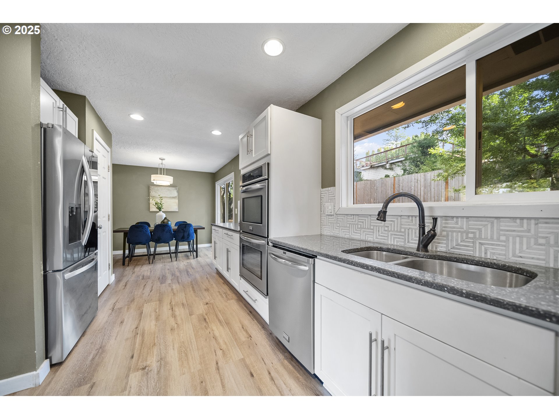 712 Southwest 4th Street Gresham, OR 97080 - Photo 16 of 47 a kitchen with sink a refrigerator and wooden floor