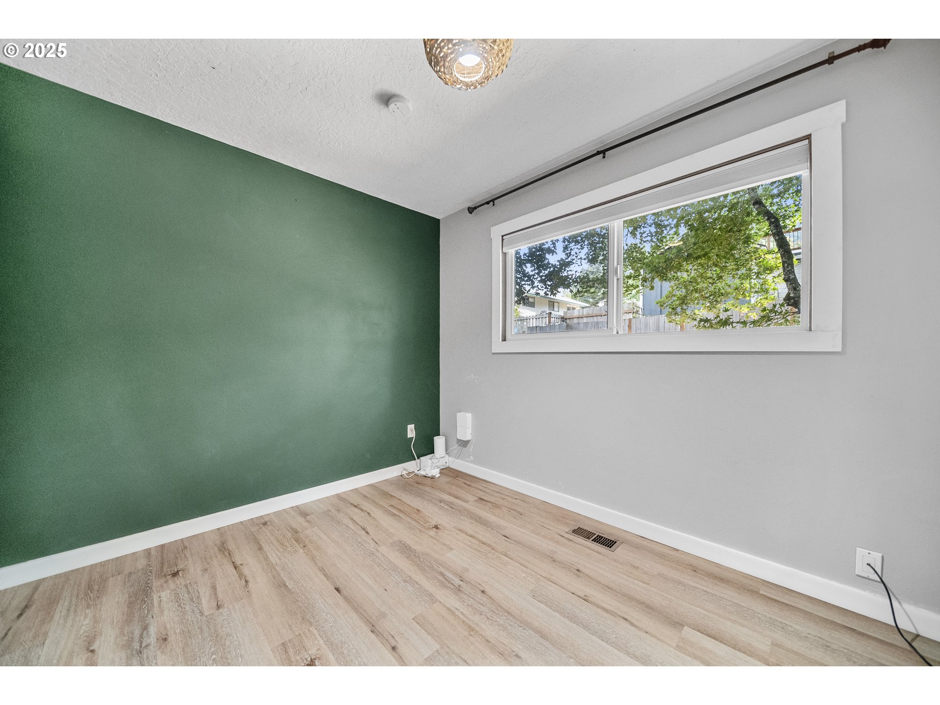 712 Southwest 4th Street Gresham, OR 97080 - Photo 25 of 47 an empty room with wooden floor and windows