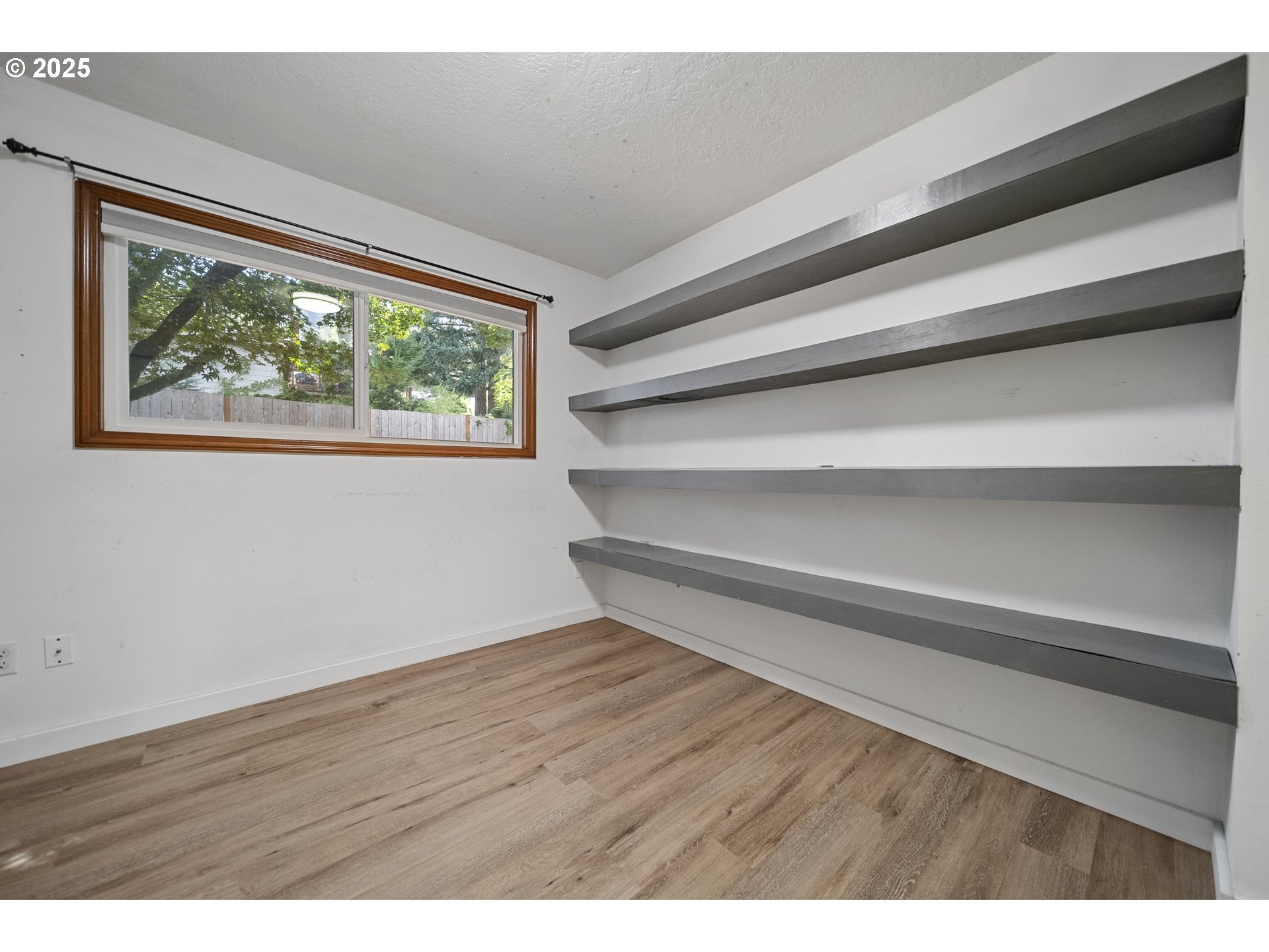 712 Southwest 4th Street Gresham, OR 97080 - Photo 29 of 47 a view of an empty room with wooden floor and a window