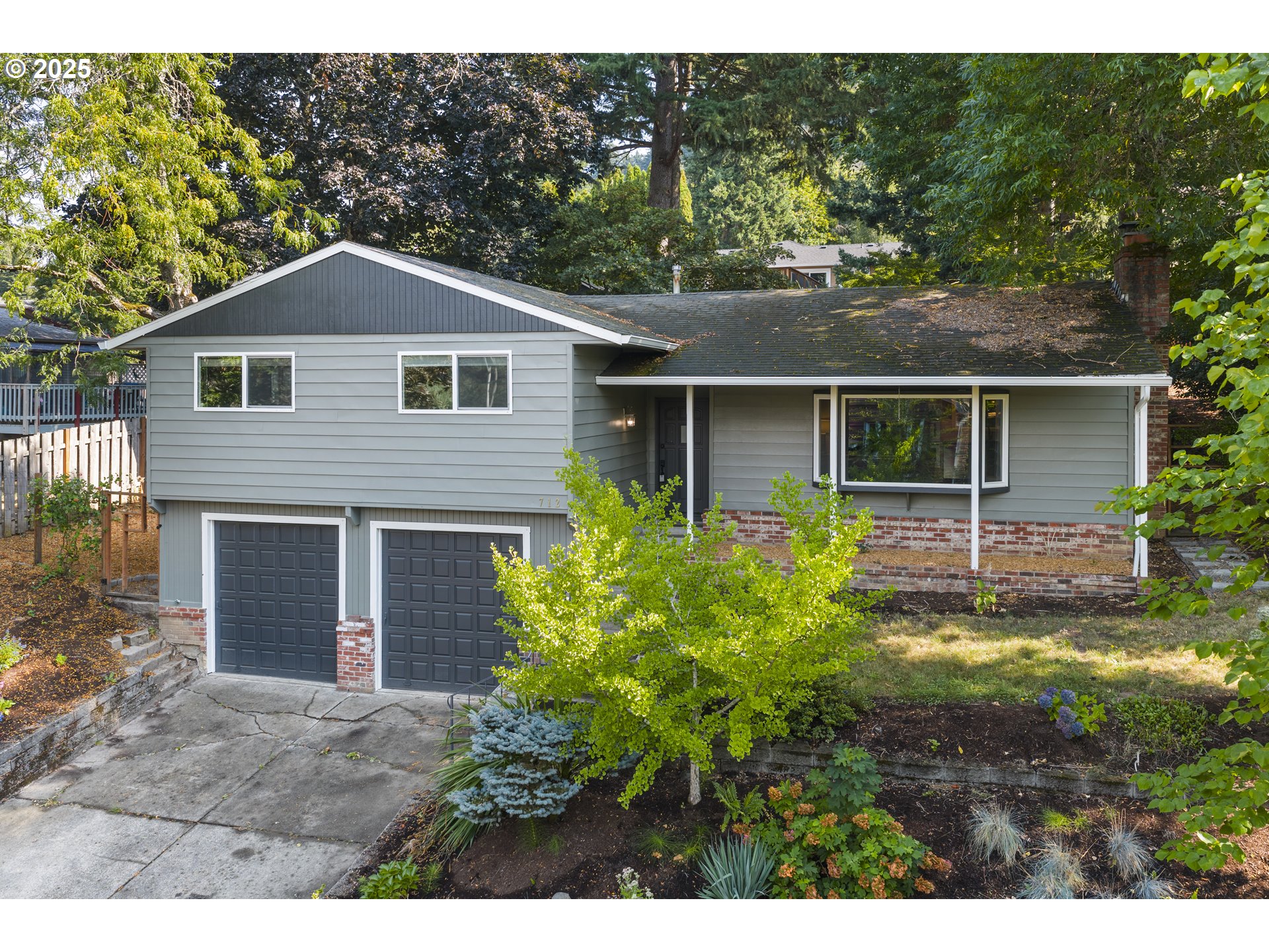 712 Southwest 4th Street Gresham, OR 97080 - Photo 3 of 47 a front view of a house with a yard and garage
