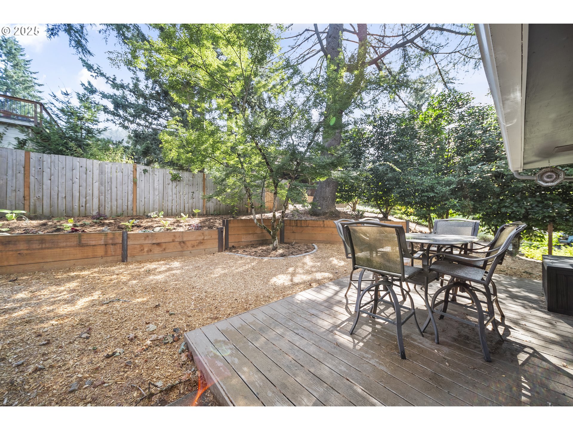 712 Southwest 4th Street Gresham, OR 97080 - Photo 35 of 47 a view of a backyard with a dining table and chairs with wooden floor