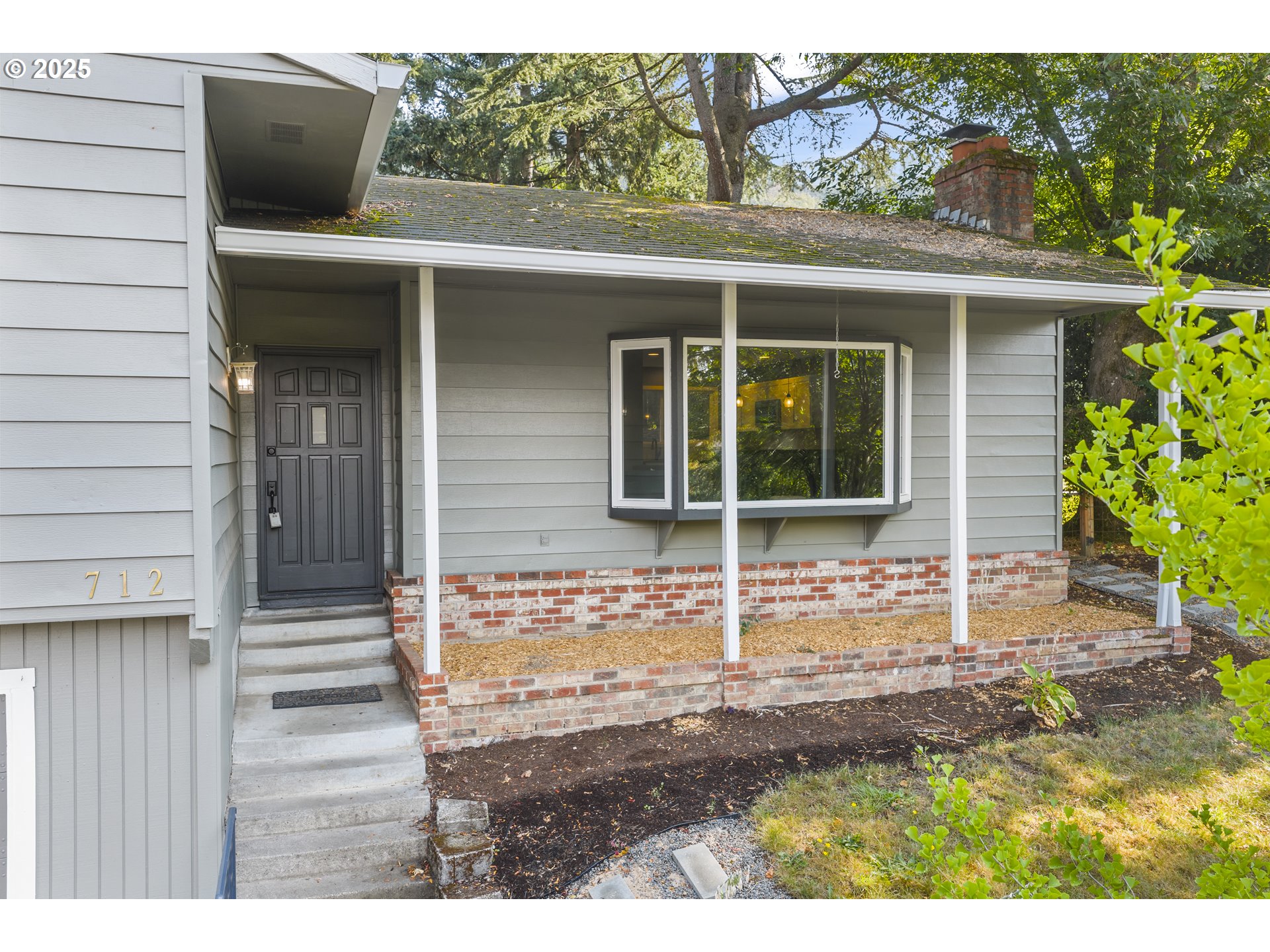 712 Southwest 4th Street Gresham, OR 97080 - Photo 4 of 47 a view of a house with a door and wooden fence