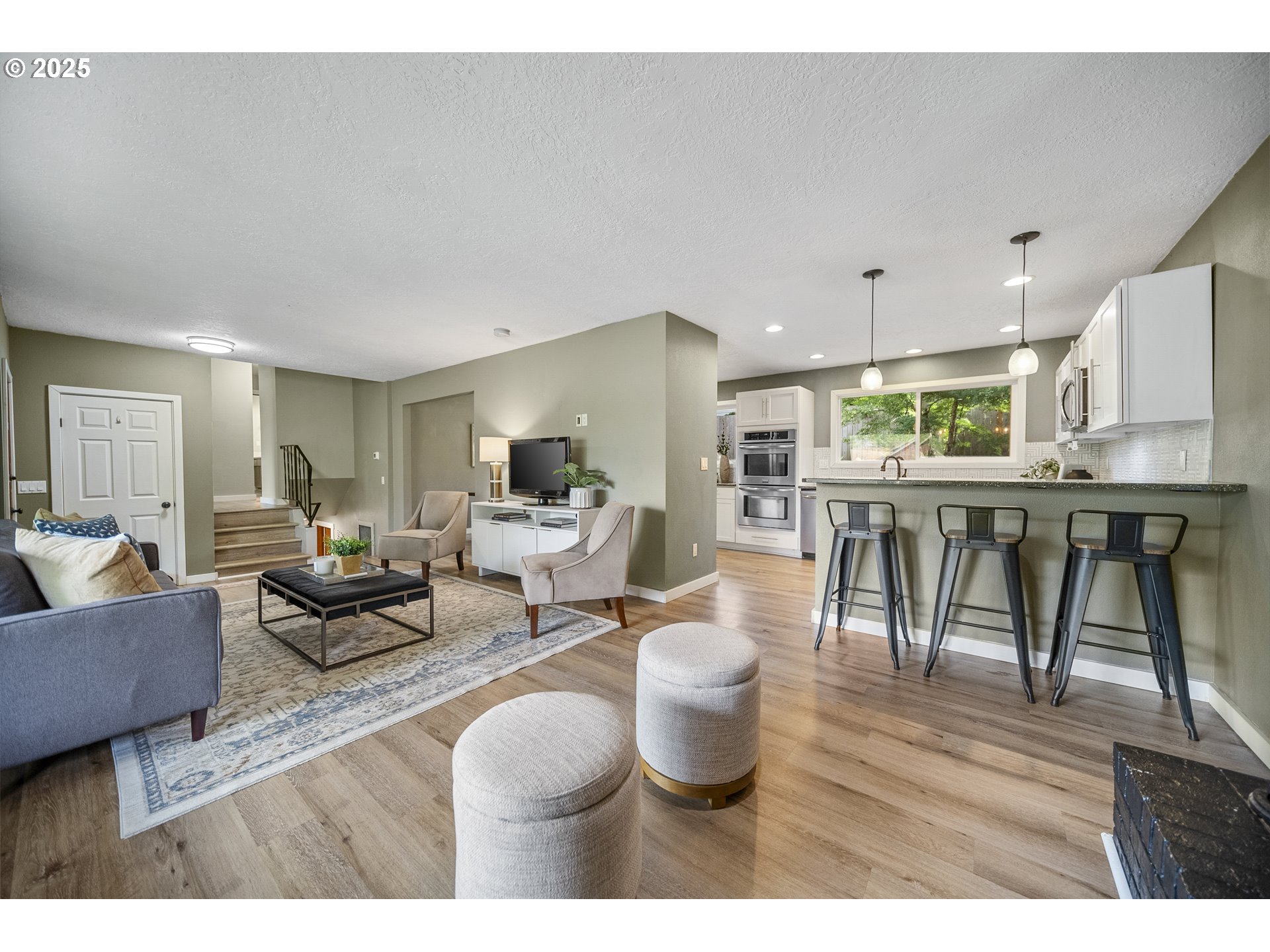 712 Southwest 4th Street Gresham, OR 97080 - Photo 8 of 47 a living room with furniture a table and kitchen view