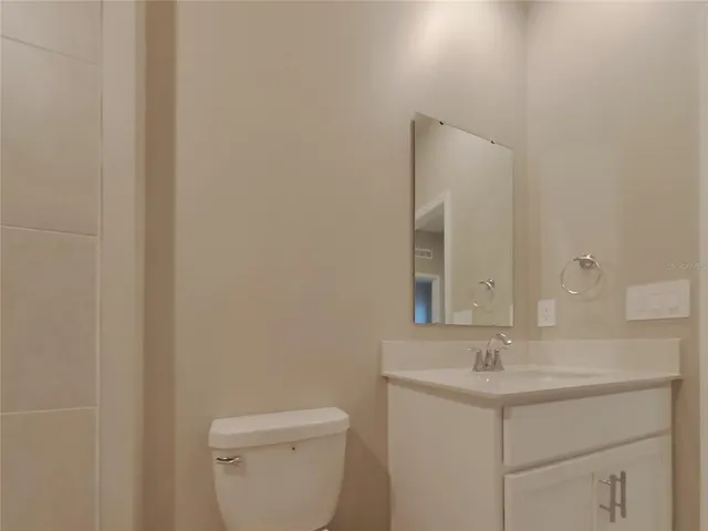 a bathroom with a sink a toilet and mirror