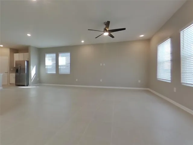 an empty room with closet and windows