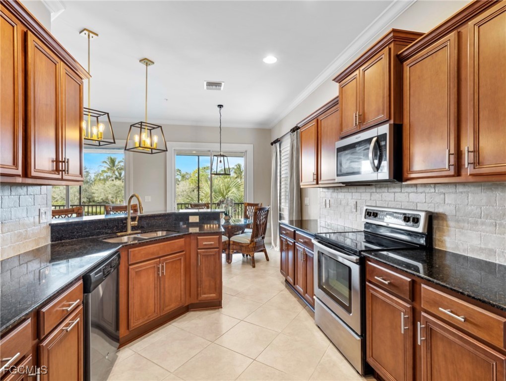 12894 New Market Street, Unit 202 Fort Myers, FL 33913 - Photo 15 of 44 a kitchen with stainless steel appliances a sink stove and cabinets