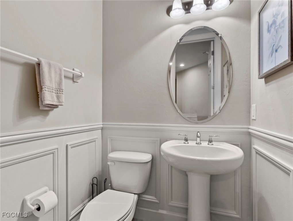 12894 New Market Street, Unit 202 Fort Myers, FL 33913 - Photo 24 of 44 a bathroom with a toilet sink and mirror