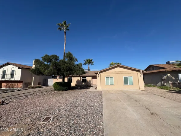a view of a house with patio next to a yard