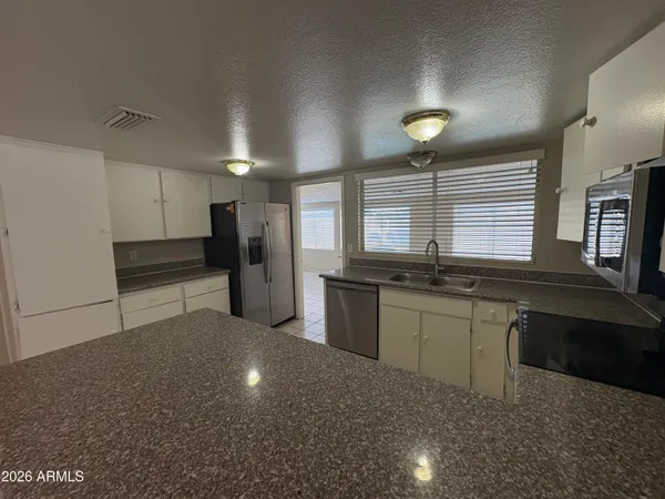 a kitchen with a sink and refrigerator