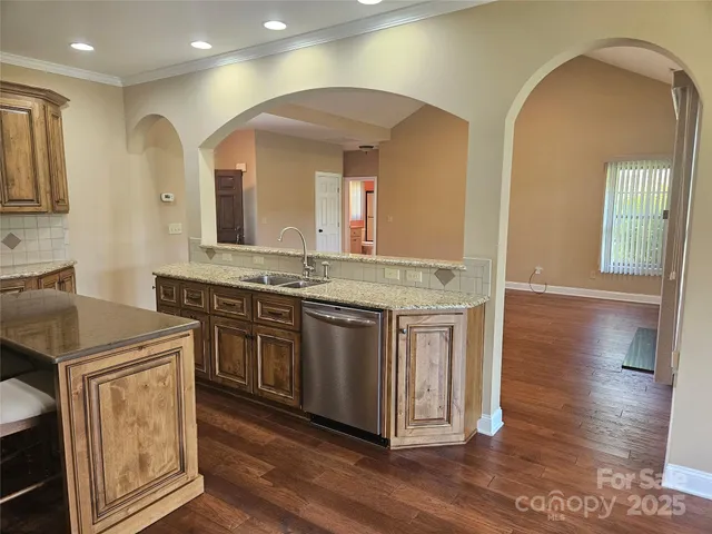 a spacious bathroom with a granite countertop sink and a mirror