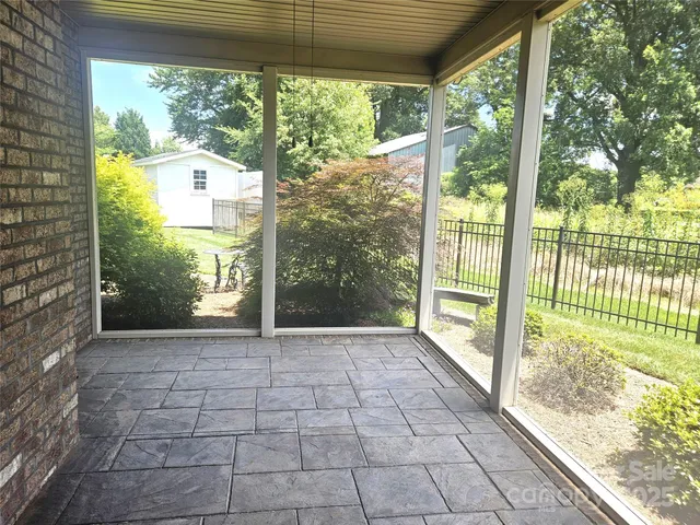 a view of porch with a floor to ceiling window and wooden fence