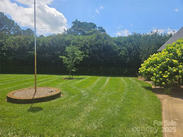 a swimming pool with lots of green space