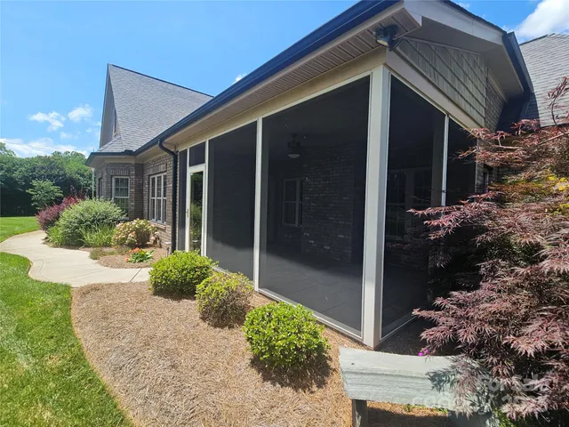 a view of a house with backyard and porch