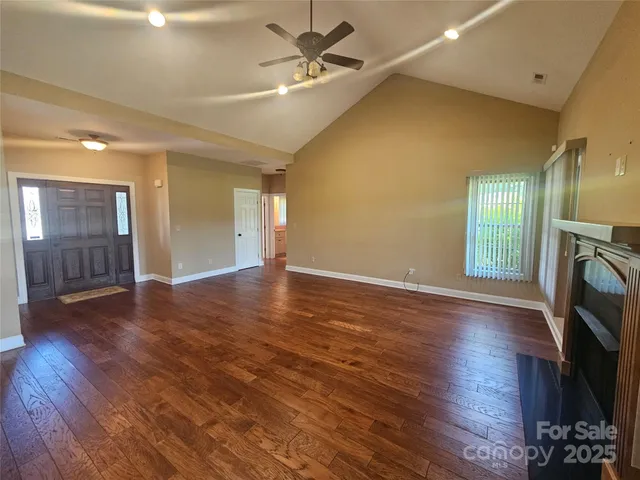 wooden floor in an empty room with a fireplace