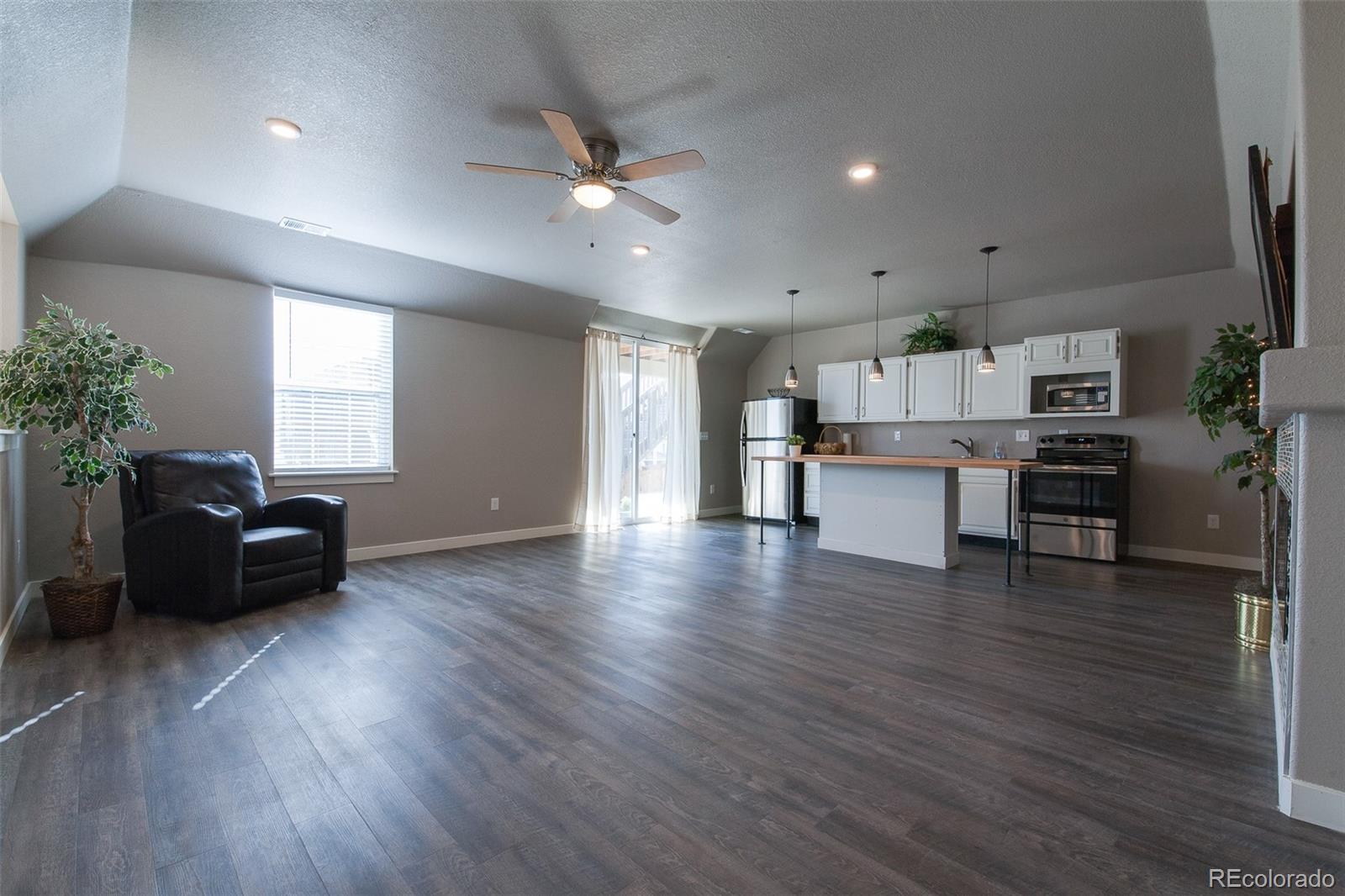 Undisclosed Address Castle Rock, CO 80104 - Photo 1 of 19 a living room with furniture and a wooden floor