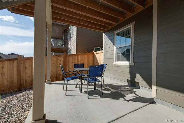 a building outdoor space with patio furniture and potted plants