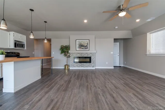 a view of a kitchen with a stove cabinets and wooden floor