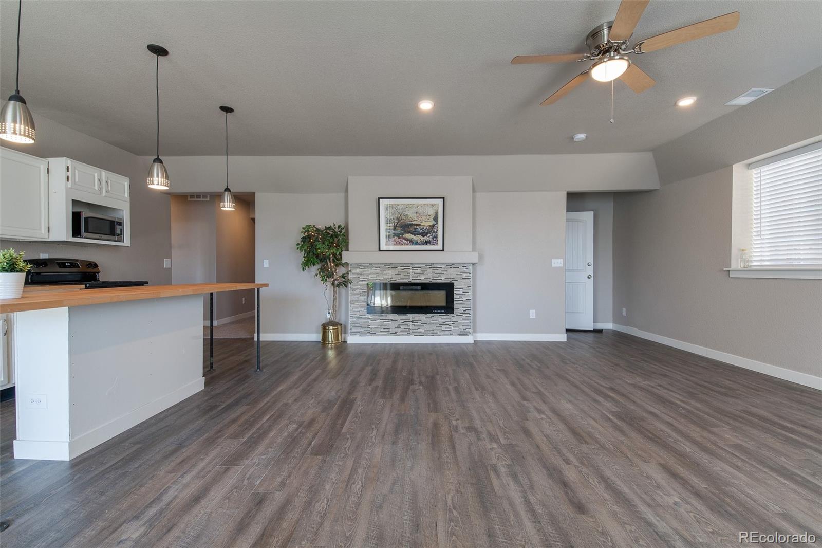 Undisclosed Address Castle Rock, CO 80104 - Photo 2 of 19 a view of a kitchen with a stove cabinets and wooden floor