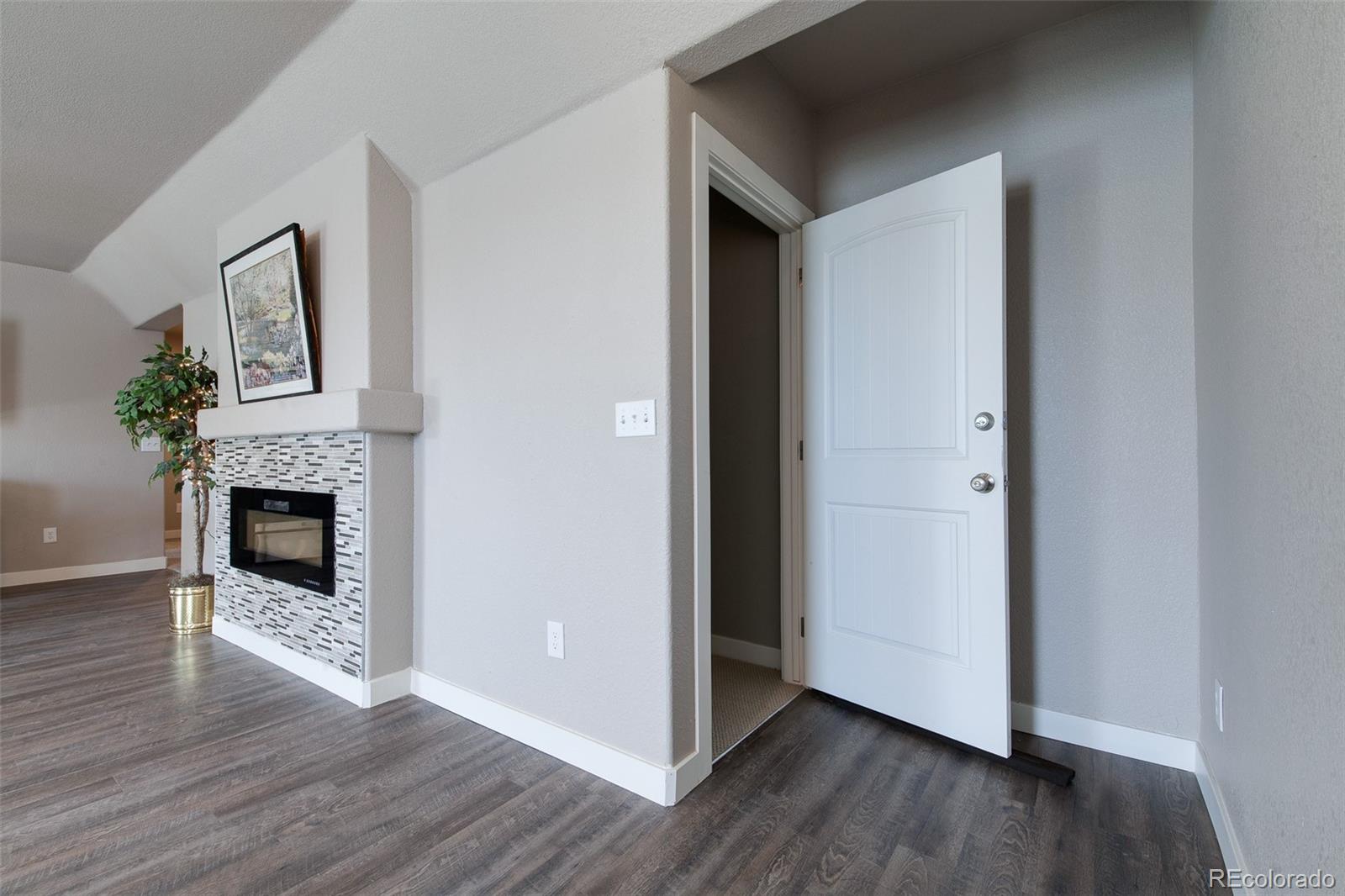 Undisclosed Address Castle Rock, CO 80104 - Photo 6 of 19 a view of a livingroom with wooden floor and a fireplace