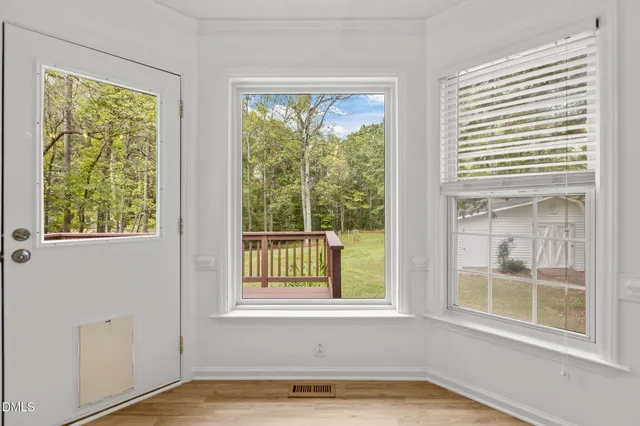 a view of a bath tub sitting in a bathroom next to a window
