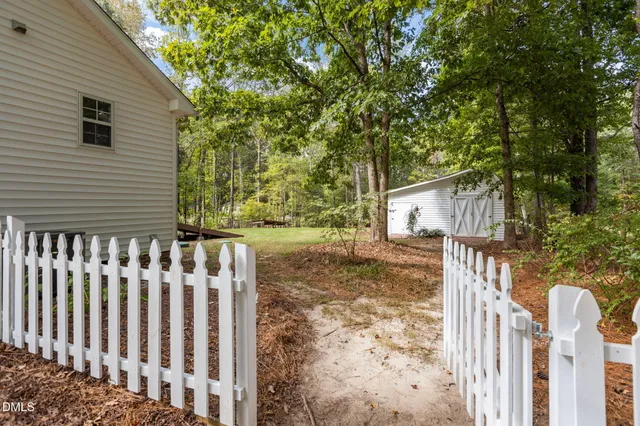 a view of a house with a yard and garage