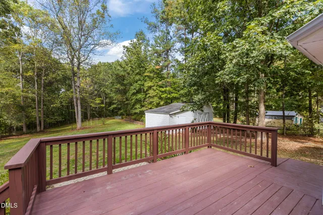 a view of balcony with wooden floor and fence