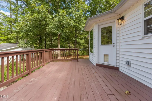 a view of a house with a yard and large tree