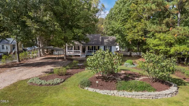 a view of a garden with a house