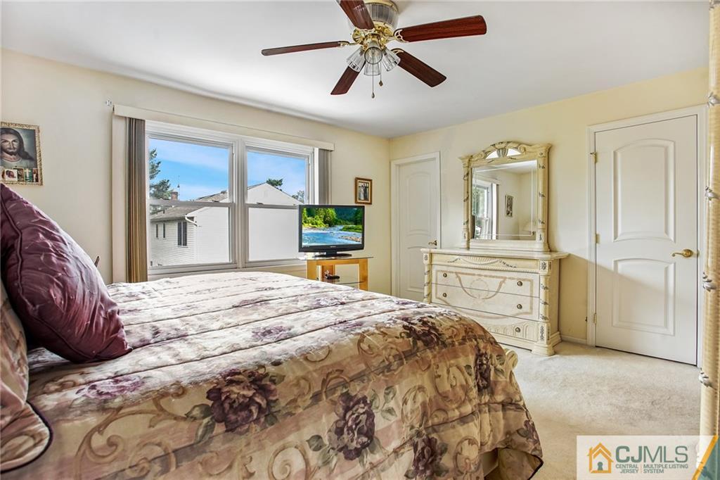 100 Vineyard Road Edison, NJ 08817 - Photo 14 of 19 a bedroom with a bed and a chandelier