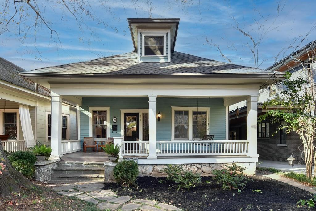 Classic Inman Park Bungalow with granite foundation, tongue and groove front porch with headboard ceiling and porch swing.