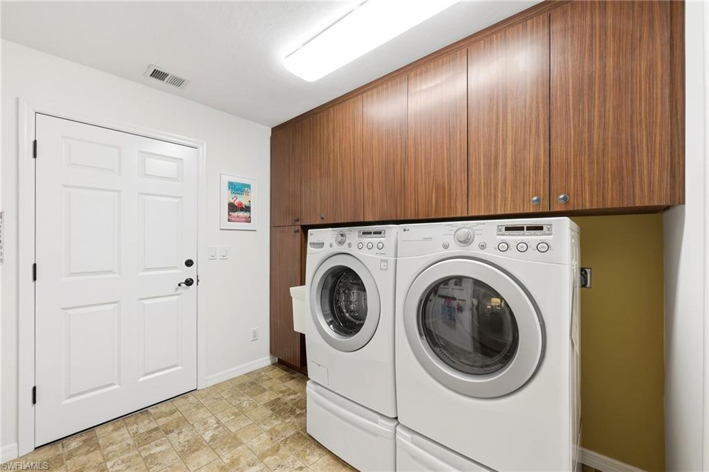 2274 Queens Way Naples, FL 34112 - Photo 23 of 28 a view of a hallway with washer and dryer