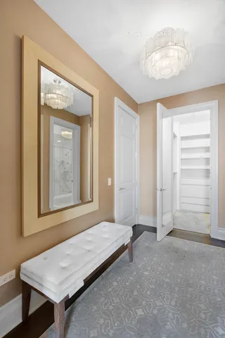 a bedroom with a bed couch and a potted plant