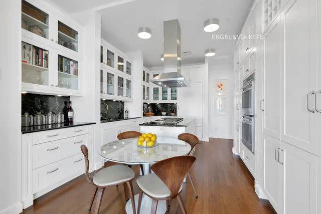 a kitchen with a stove a refrigerator and wooden cabinets