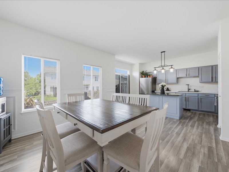 4201 Dillon Street Plano, IL 60545 - Photo 14 of 37 a kitchen with kitchen island a table and chairs in it