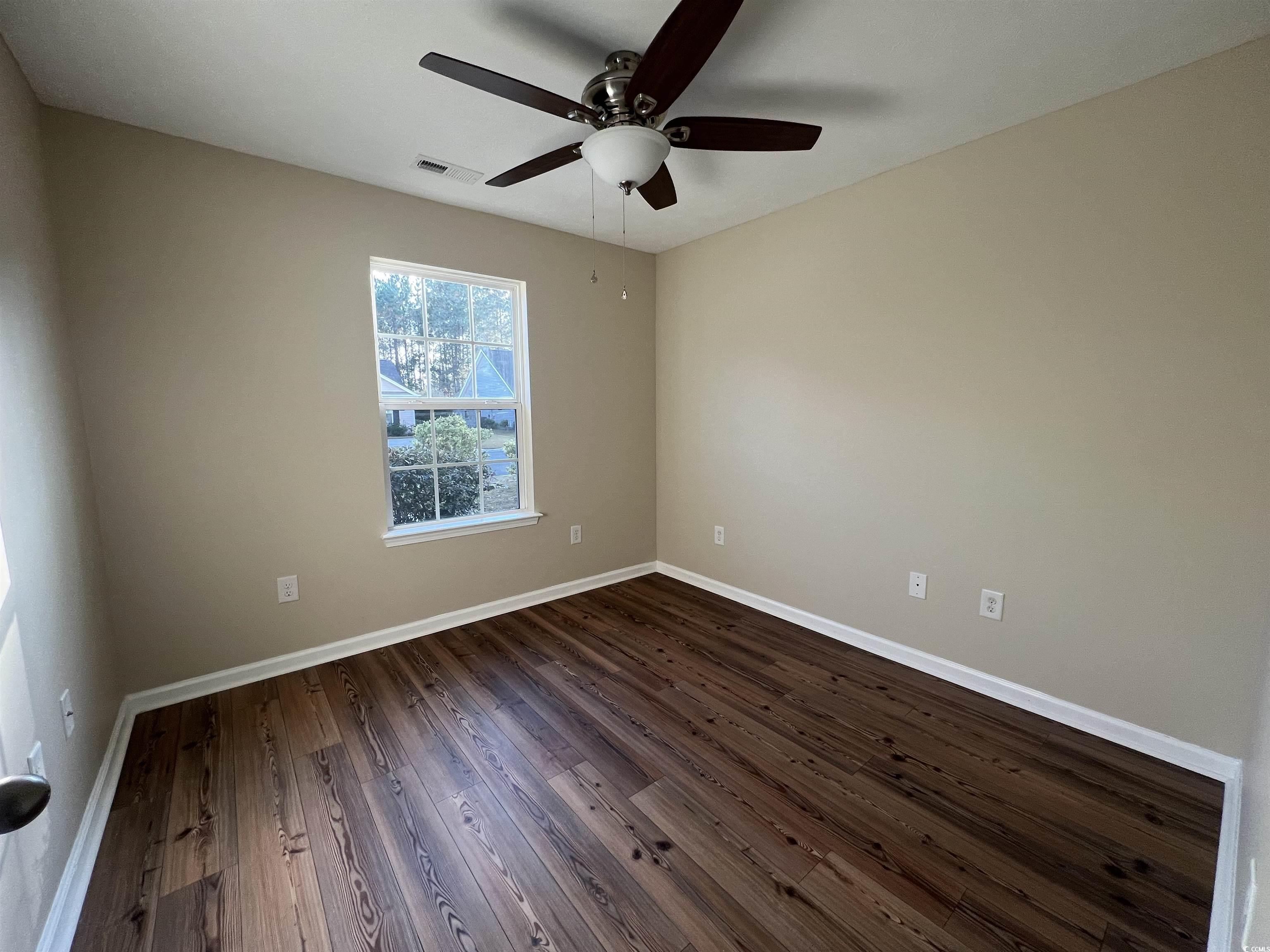 225 Upper Saddle Circle Conway, SC 29526 - Photo 13 of 24 Spare room featuring dark wood-type flooring and a ceiling fan