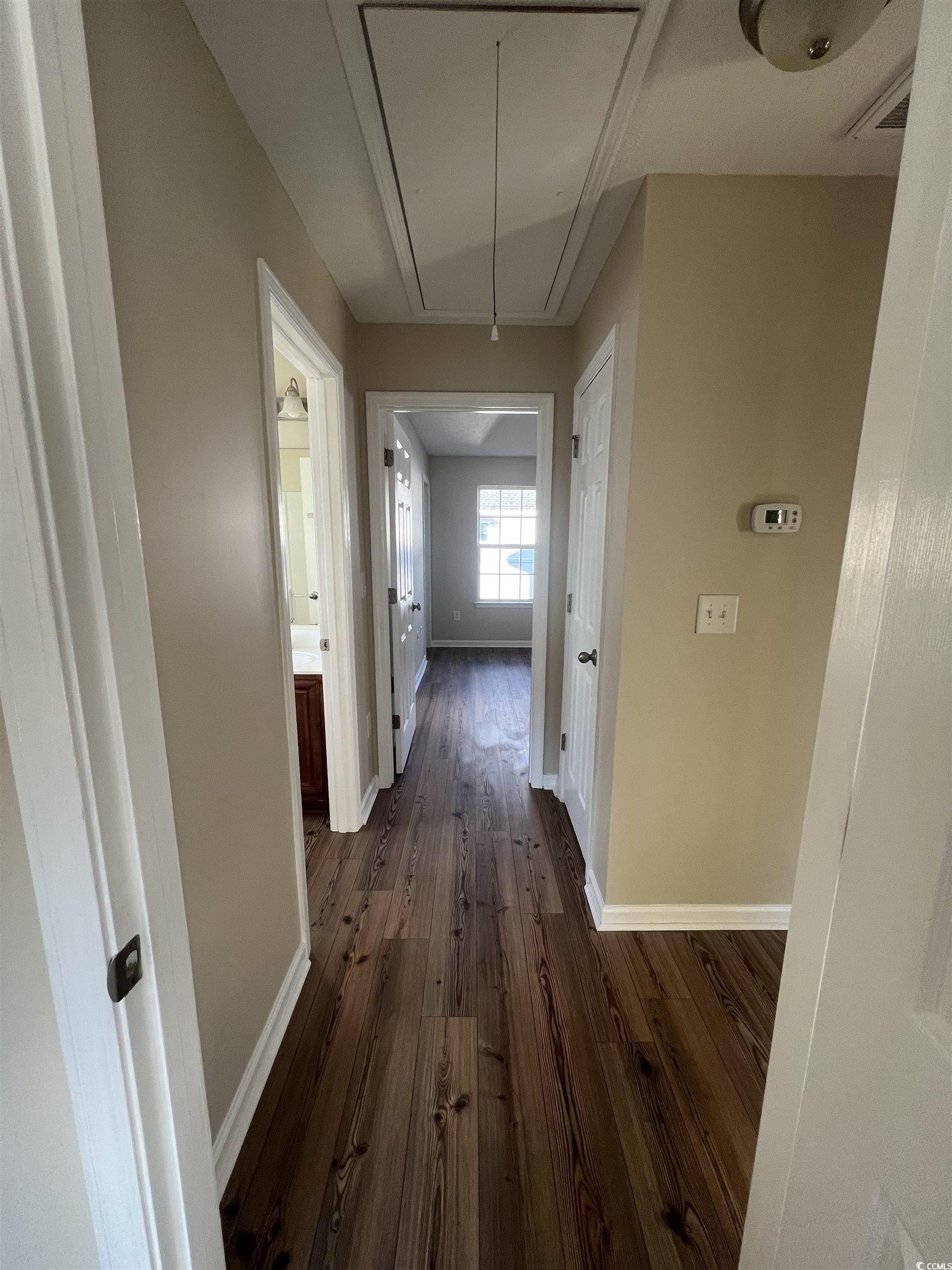 225 Upper Saddle Circle Conway, SC 29526 - Photo 14 of 24 Hall with attic access and dark wood-type flooring