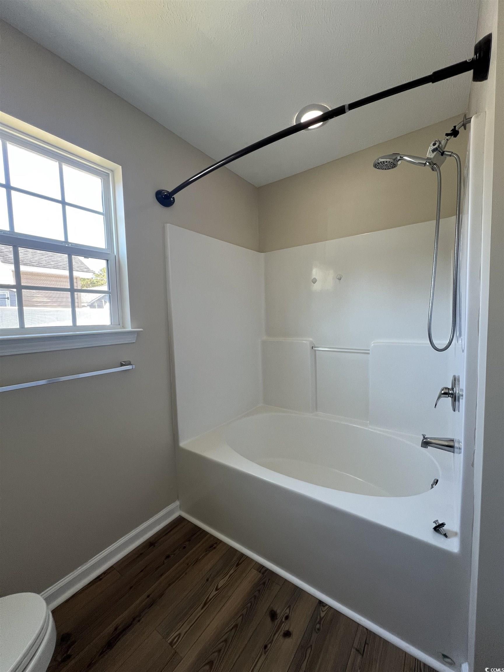 225 Upper Saddle Circle Conway, SC 29526 - Photo 17 of 24 Bathroom with tub / shower combination, dark wood finished floors, and a textured ceiling