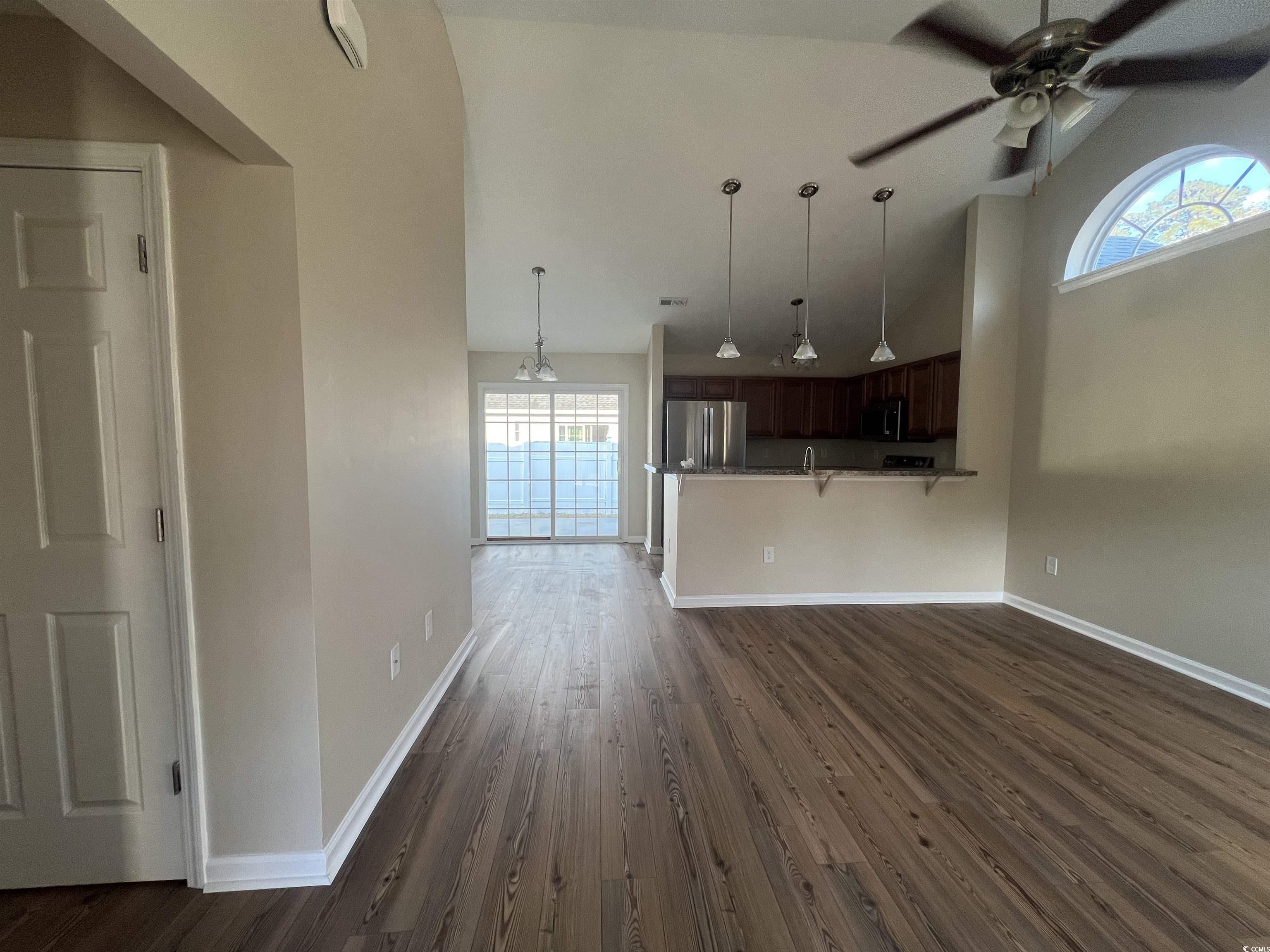 225 Upper Saddle Circle Conway, SC 29526 - Photo 6 of 24 Unfurnished living room featuring high vaulted ceiling, dark wood-style flooring, and ceiling fan