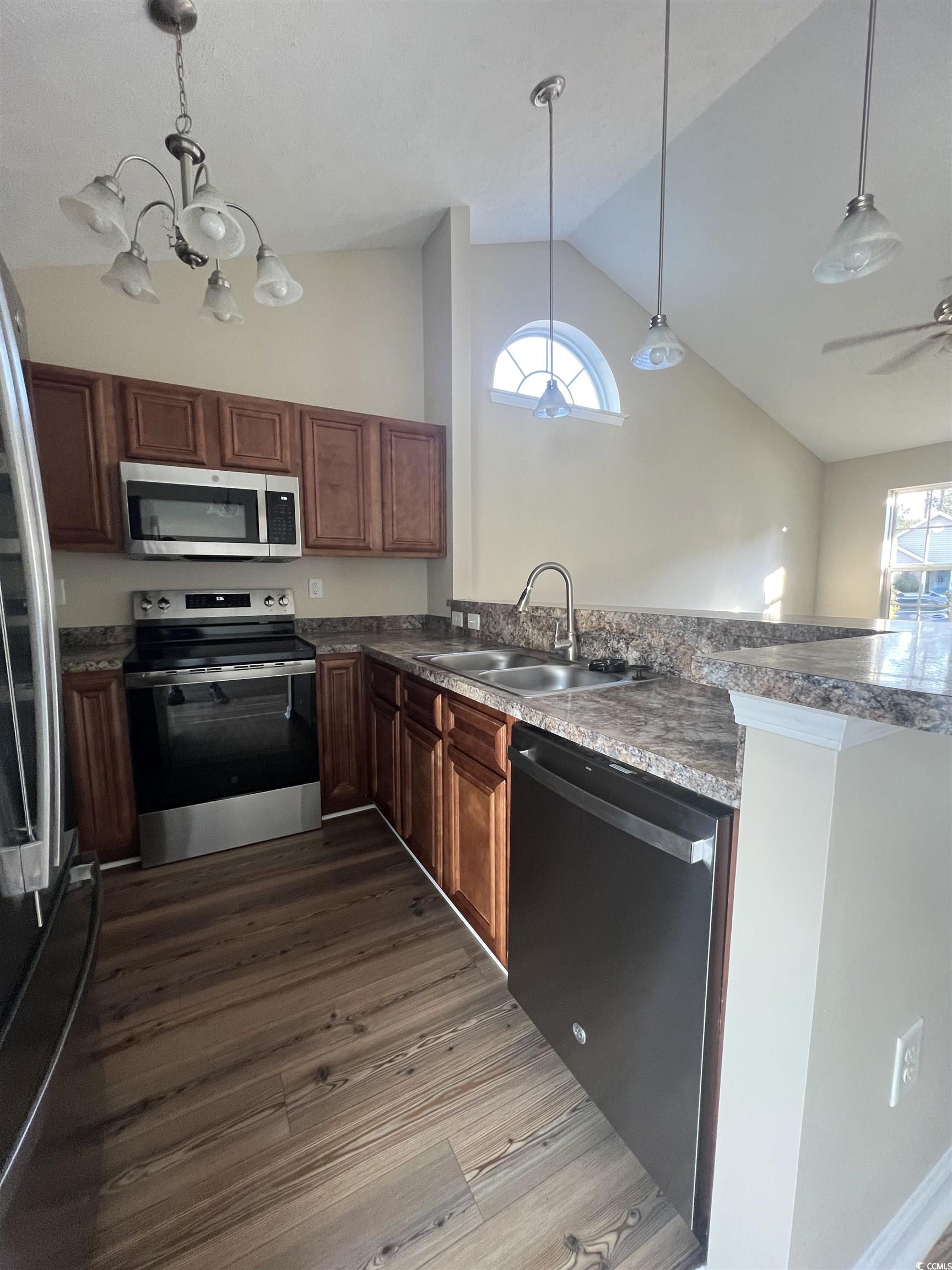225 Upper Saddle Circle Conway, SC 29526 - Photo 9 of 24 Kitchen with appliances with stainless steel finishes, hanging light fixtures, dark countertops, dark wood finished floors, and a peninsula