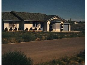 3927 North Reed Road Chino Valley, AZ 86323 - Photo 1 of 1 a front view of a house with a yard and garage
