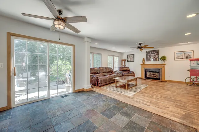 a living room with furniture large window and a fireplace