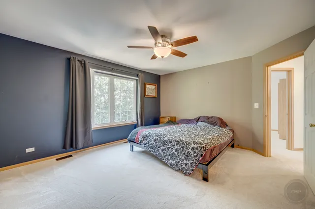 a bedroom with a bed and window